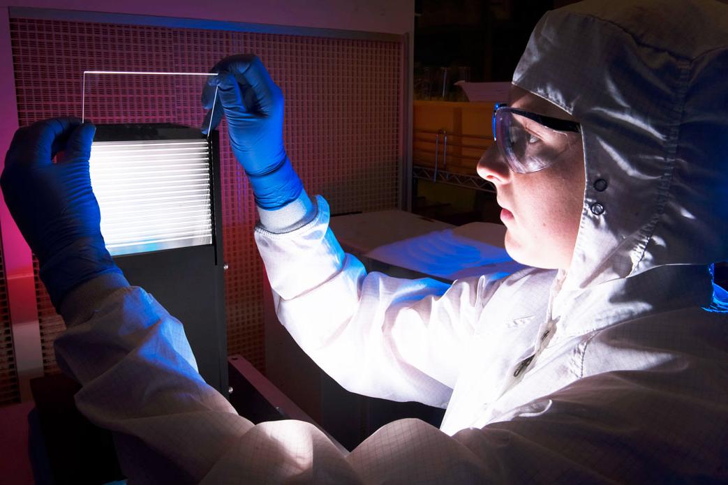 Student at a workbench with a laser